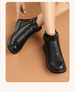 Close-up of black leather ankle boots for women featuring side zipper and warm lining