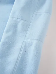 Macro view of premium soft light blue polar fleece fabric texture and high-quality stitching