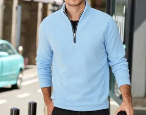 Macro view of light blue polar fleece fabric and half-zip collar detail on mens pullover