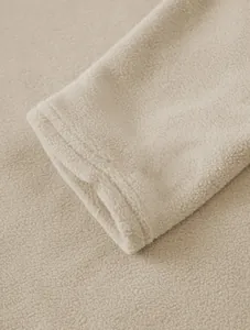 Close-up detail of soft beige rocker fleece sweatshirt cuff with high-quality stitching