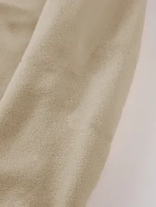 Close-up macro view of soft beige polar fleece fabric texture for men's sweatshirt