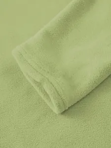 Close-up macro view showing soft polar fleece texture and sleeve cuff detail of a green hoodie