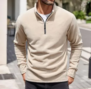 Detail of men's beige heavy fleece half-zip sweatshirt with stand-up collar and soft texture