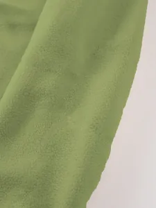 Macro view of soft green polar fleece fabric texture for a men's stand collar sweatshirt.