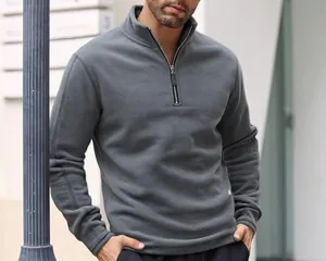 Detail view of men's thick grey fleece sweatshirt with half-zip and stand collar