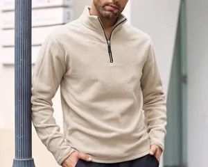 Detail of a beige men's polar fleece sweatshirt featuring a half-zip and stand collar