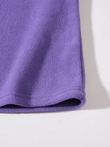 Detailed macro view of soft purple polar fleece fabric texture and durable stitched hem