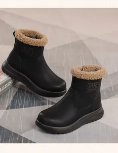 Detailed shot of black women's winter snow boots featuring warm faux fur lining and thick soles.