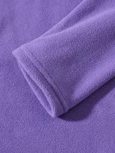 Close-up detail of the sleeve and soft texture of a purple men's fleece sweatshirt