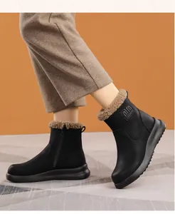 Side view of elegant black women's winter snow boots with warm faux fur lining and side zipper.