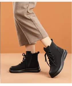 Macro detail of black leather winter ankle boots featuring side zipper and soft sole