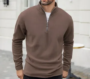 Detail view of men's brown polar fleece sweatshirt with half-zip stand collar.
