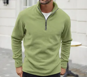 Detailed view of the half-zip mock neck and soft fleece texture on this green sweatshirt
