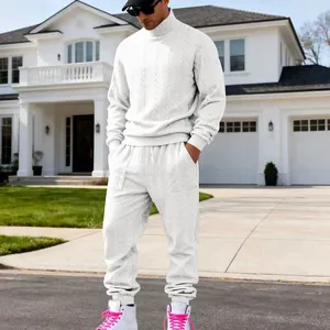 Detailed view of the men's white cable-knit turtleneck sweater and tracksuit set