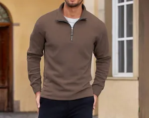 Close-up detail of men's brown polar fleece sweatshirt with stand collar and zipper.