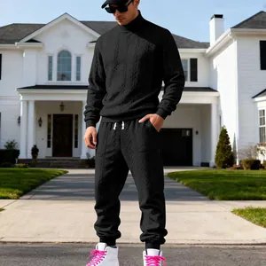 Detailed view of men's heavy black jacquard cable knit tracksuit with high neck