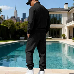 Detailed back view of men's black heavy cable-knit leisure tracksuit set by a luxury pool