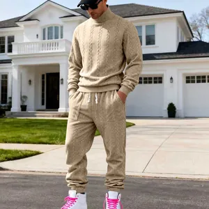 Detail view of men's beige knitted turtleneck sweater and jogger pants set for autumn winter
