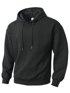 Macro detail of men's black hoodie featuring premium cable-knit texture and drawstring