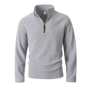 Detail showing the half-zip stand collar and texture of the grey polar fleece sweatshirt.