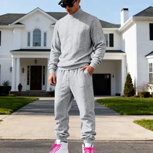 Detail view of men's grey cable-knit turtleneck sweater and matching joggers set outfit.