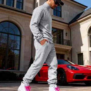 Detailed shot of a men's heavy grey cable-knit tracksuit featuring a turtleneck sweater