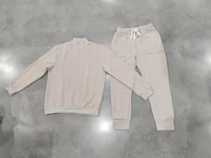 Detailed view of men's beige jacquard lounge set with high neck and drawstring pants.