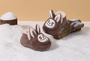 Brown plush children's winter boots featuring a cute cartoon bunny face design in snow