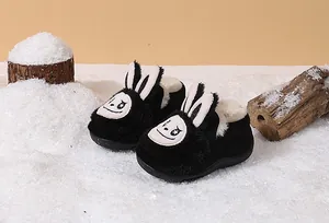 Warm black bunny ear plush toddler boots for winter outdoors snow scene details