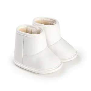 Close-up of white baby winter boots featuring warm faux fur lining and a soft sole