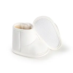 Detail shot of white fleece-lined baby winter boots featuring anti-slip soft soles