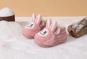 Close-up detail of pink plush toddler snow boots with a cute cartoon rabbit design