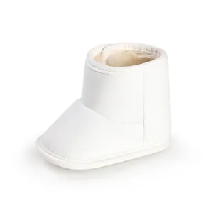 Close-up of white fleece-lined baby winter boots with soft non-slip soles.