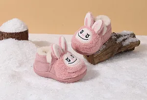Detailed view of pink fuzzy toddler winter boots featuring cute rabbit cartoon ears and warm lining