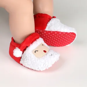 Close-up of cozy red Christmas Santa baby shoes with soft white fleece and anti-slip soles