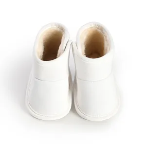 Close-up view of the warm fleece lining and velcro strap on white baby winter boots