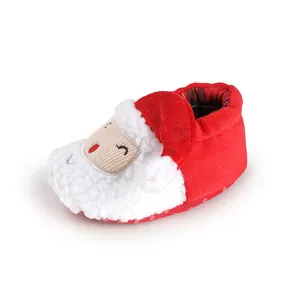 Detail shot of plush Christmas Santa baby shoe with soft red fabric and white faux fur