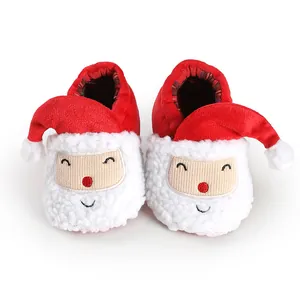 Detailed view of plush Santa Claus themed baby winter booties with soft white fur trim