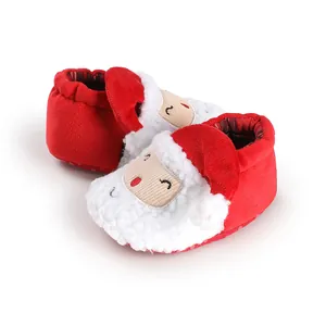 Detailed view of red Santa Claus themed winter baby walking shoes for newborns