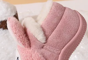 Close-up of soft pink faux fur lining and plush texture on warm toddler winter snow boots