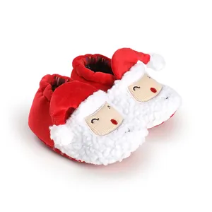 Close-up of Santa Claus baby shoes with soft white fleece and red plush fabric