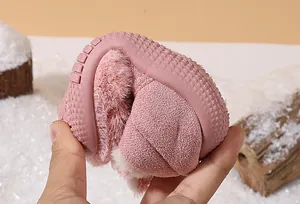 Close-up showing the flexible and soft rubber sole of pink fuzzy winter toddler shoes.