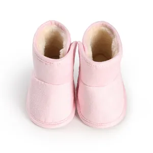 Top view of pink baby winter boots showing warm fleece lining and soft suede texture