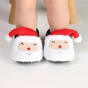 Detail shot of plush Christmas Santa baby shoes with cute red hats and white fleece.