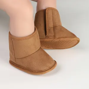 Close-up of brown suede baby winter boots with soft anti-slip sole and velcro strap
