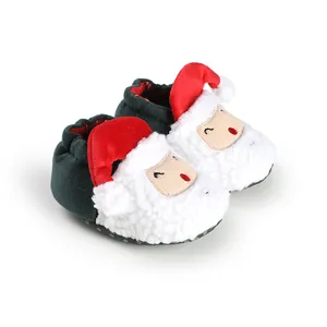Close-up detail of cozy Christmas sheep baby shoes with white fuzzy texture and red hat detail