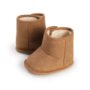 Detailed view of brown suede baby winter boots with soft warm white faux fur lining