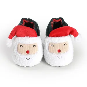 Close-up of cute Santa Claus themed plush baby winter walking shoes for newborns and infants.