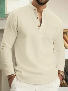 Close-up of beige waffle knit men's long-sleeved Henley shirt with chest pocket detail