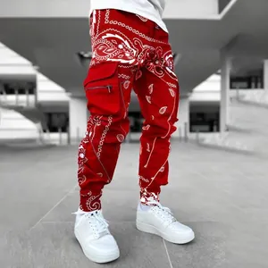 Red paisley print men's cargo harem pants in street style with white sneakers.